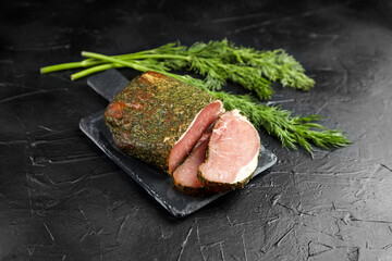 Polendwitz is a jerky tenderloin, dried pork with spices and fresh green dill, slate cutting board on black stone table