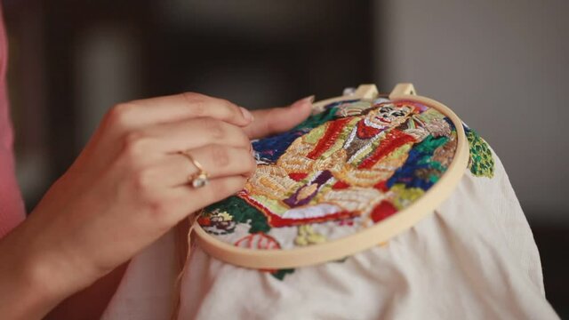 Woman doing traditional indian embroidery