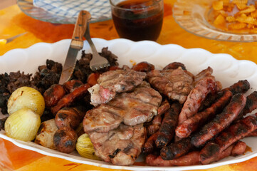 Barbecued meat on a white plate