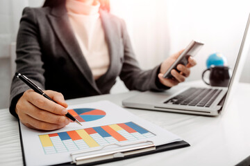 Digital marketing media in virtual screen.businesswoman hand working with mobile phone and modern compute with VR icon diagram at office in morning light