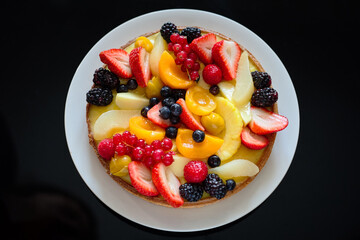 Fresh Fruit cake on a black background