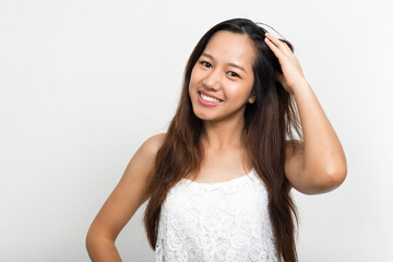 Portrait of happy young beautiful Asian woman
