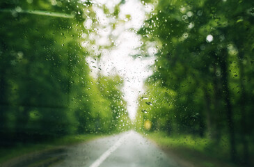 View through the windshield of car on the asphalt country wet road after the rain.