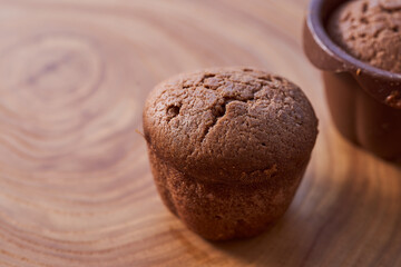 Homemade chocolate cupcakes on a wooden table. Close-up. With copy space.