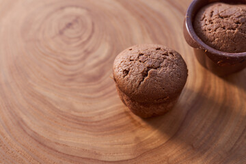 Homemade chocolate cupcakes on a wooden table. Close-up. With copy space.
