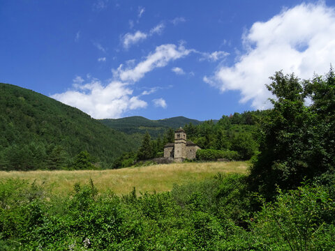 Green landscape with the view of the Mozarab Pre-Romanesque or Romanesque Church of San Bartolome de Gav&iacute;n in the Serrablo Region. 10th-11th century. Aragon. Spain.
