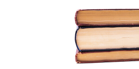 Three old books lie one on one, a pile from the side on a white background top view in profile. The top of the book on a white background lies