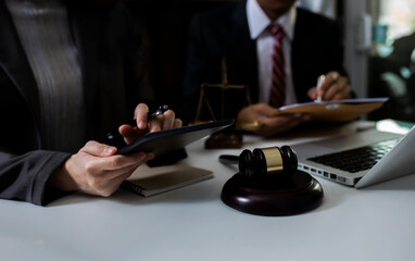Concept of Law and Legal services. Lawyer working on digital at table office.