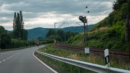 Railway near road in vale during summer