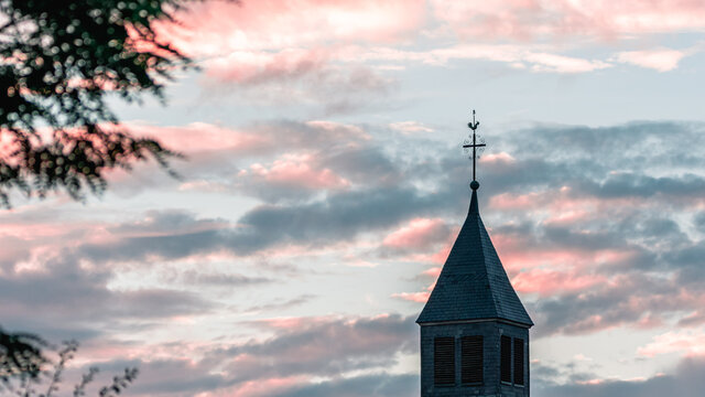 Pink evening with steeple from a french church in Alsace