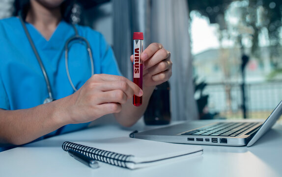 Doctor Hands Holding Coronavirus COVID 19 Blood Sample In Research Laboratory. 