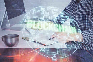 Blockchain theme hud with man working on computer on background. Concept of crypto chain. Double exposure.