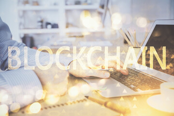 Blockchain theme hud with man working on computer on background. Concept of crypto chain. Double exposure.