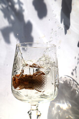 Empty glass of water with wine cork