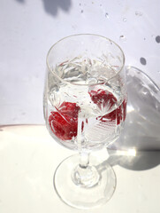 Raspberry berries in a glass of water