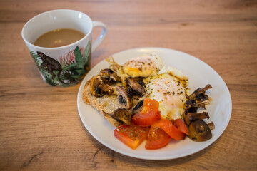 Breakfast plate with coffee on a wooden table