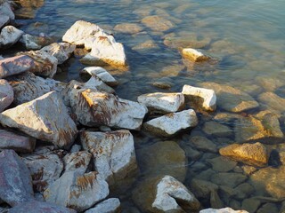 Rocky shore and clear water at the southern side of the lake Balaton in June, Hungary