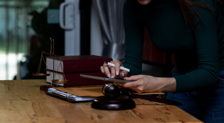 Concepts of Law and Legal services. lawyer businesswoman working on digital tablet in office.