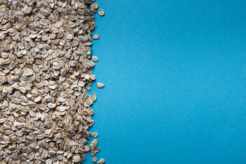 Rolled oats background with large blue copy space