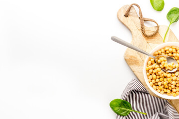 Vegetarian bowl with chickpeas and vegetables - white table top view copy space