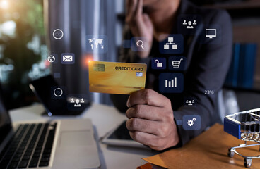 Businessman holding a credit card with network icons.