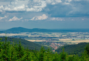 Green forest in mountains of Sudetes and view on the city, Poland