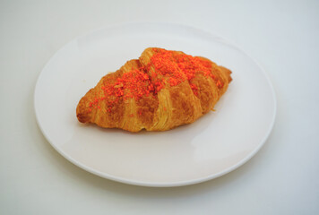 fresh sliced salted egg croissant with fork on the white plate with copy space