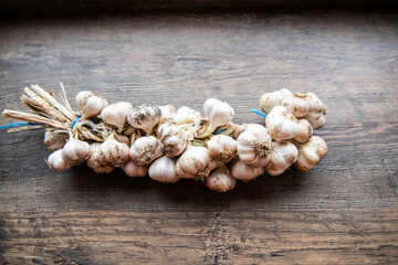 wreath of garlic on a dark wooden background
