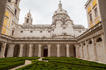 Fototapeta na wymiar Palace of Mafra, Portugal. History landmark in cloud day