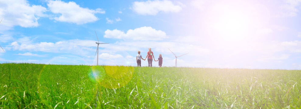 Family Looking At Wind Mill- Green Electricity, Renewable Energy, Ecology Concept