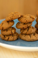 Very tasty peanut butter biscuits on bamboo light brown wooden board, golden baked healthy