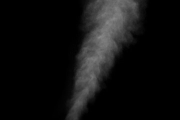 Abstract steam with dots of spray moves on a black background. Figured smoke can be used for design