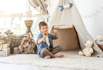 Little boy with wood slingshot