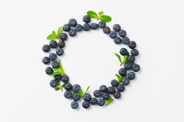 Circle of blueberries on white background, top view