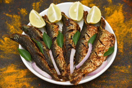 Sardine fish fry or pilchard fry fish curry with salad tasty sea food cuisine, Kerala India. Popular dish in coastal area restaurant,  mathi or chala meen fry best served with rice.