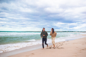 Young family on the beach in the storm