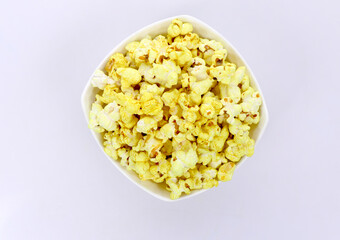 Tasty popcorn in a bowl isolated on dark Background. Snack for a movie