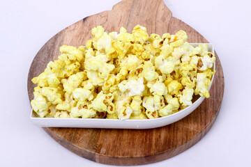 Popcorn in a bowl on wooden. Snack for a movie