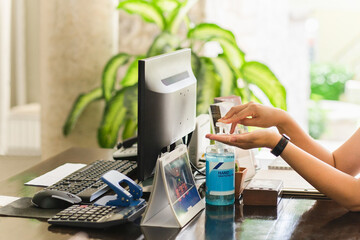Woman hand pressing alcohol gel to clean her hand prevention of covid-19.