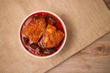 Kerala fish curry Alappuzha, India,  Hot and spicy homemade red fish Masala curry on jute...