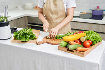 young attractive asian woman cooks in a kitchen,chicken