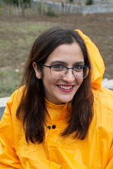 happy girl in yellow rain coat in village