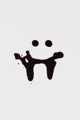 Smiling face with vampire teeth drawn in fake blood on white background. Halloween print