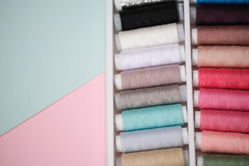 Composition of a flat layer with colored sewing threads on a multicolored background