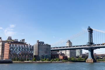 Fototapeta premium Riverfront of Dumbo Brooklyn with the Manhattan Bridge over the East River in New York City