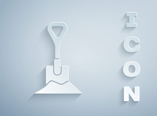 Paper cut Shovel in the ground icon isolated on grey background. Gardening tool. Tool for horticulture, agriculture, farming. Paper art style. Vector Illustration.