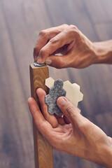 A man is attaching a floor care felt pad at chair legs