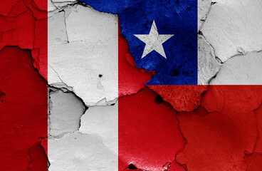 flags of Peru and Chile painted on cracked wall