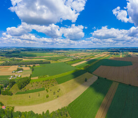 Stunning aerial panorama from a drone of countryside, village, green fields and trees, agriculture concept.