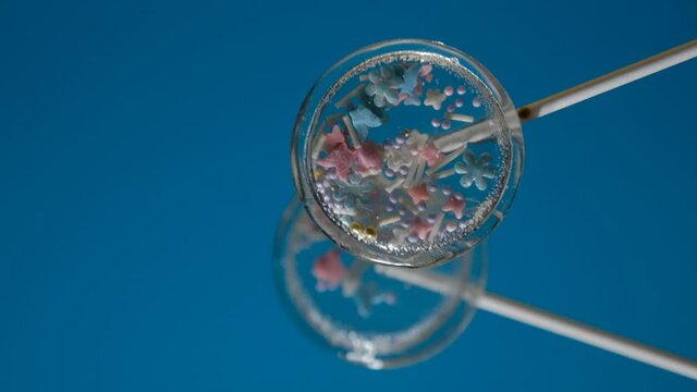 Transparent isomalt lollipops with sprinkles inside